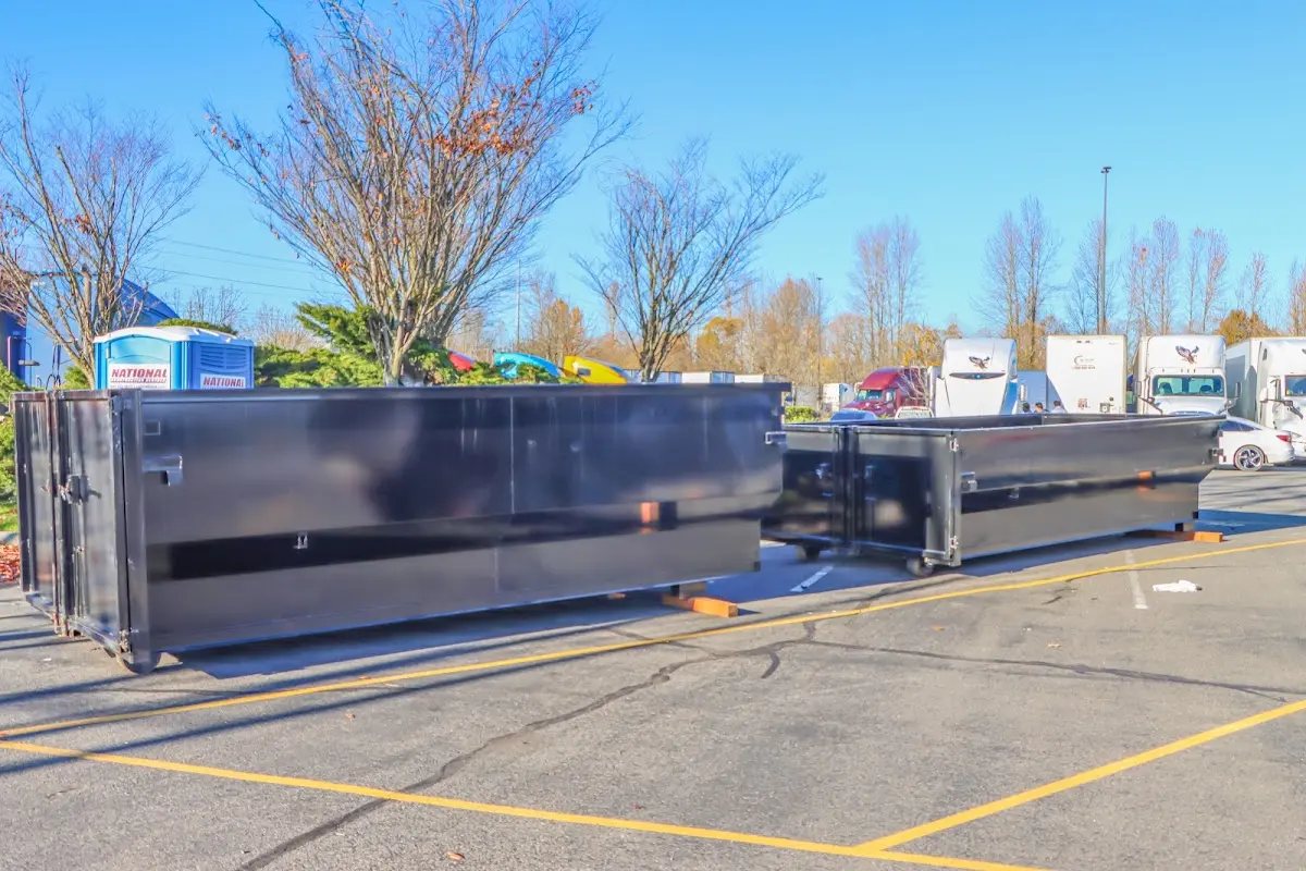 Professional dumpster rental service with roll-off container on residential driveway in Wynne